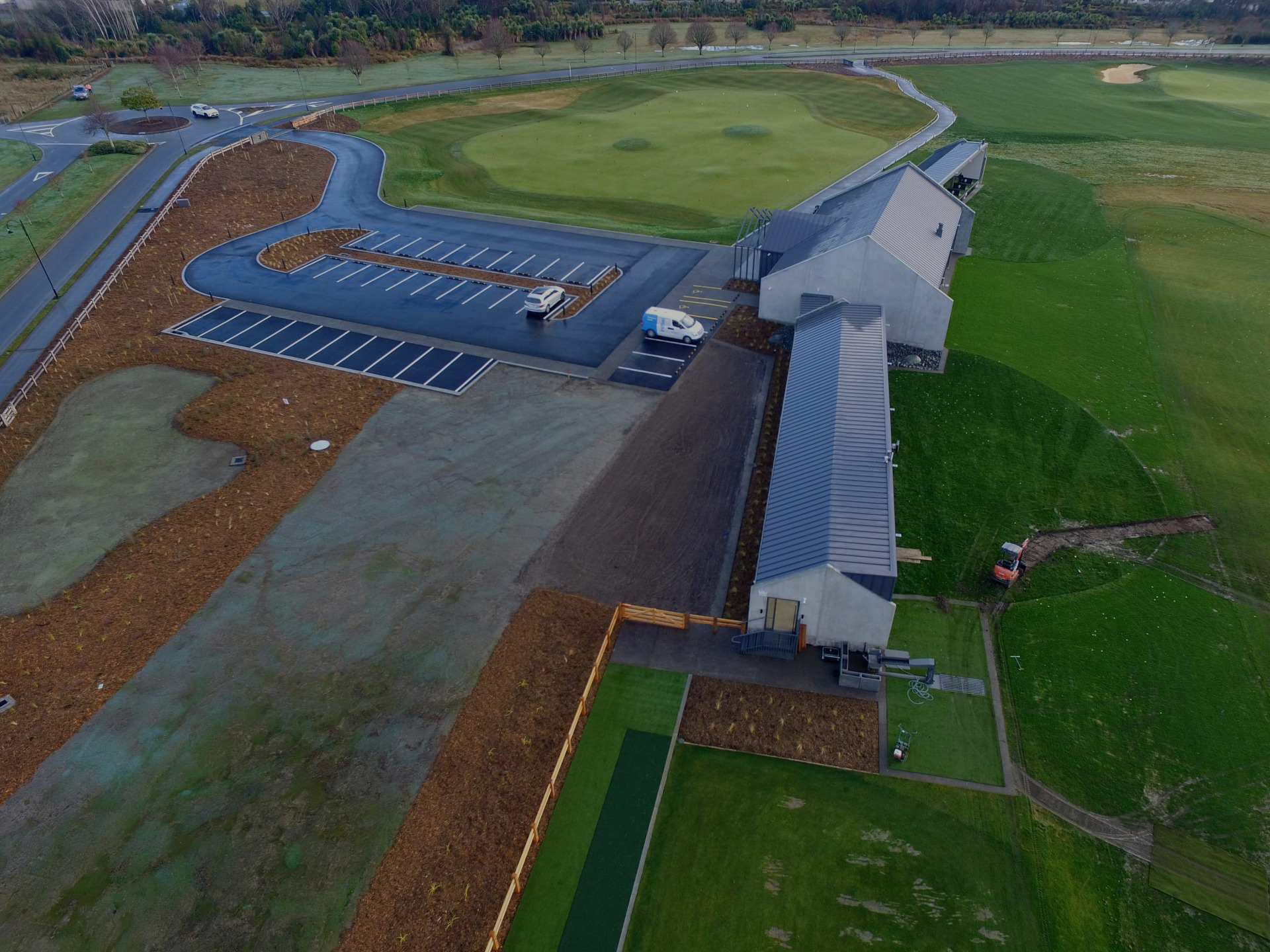 Aerial image of a completed golf course clubhouse and parking area in Canterbury built by EDR Contracting, showing finished pavements, curbing, and infrastructure ready for landscaping establishment.
